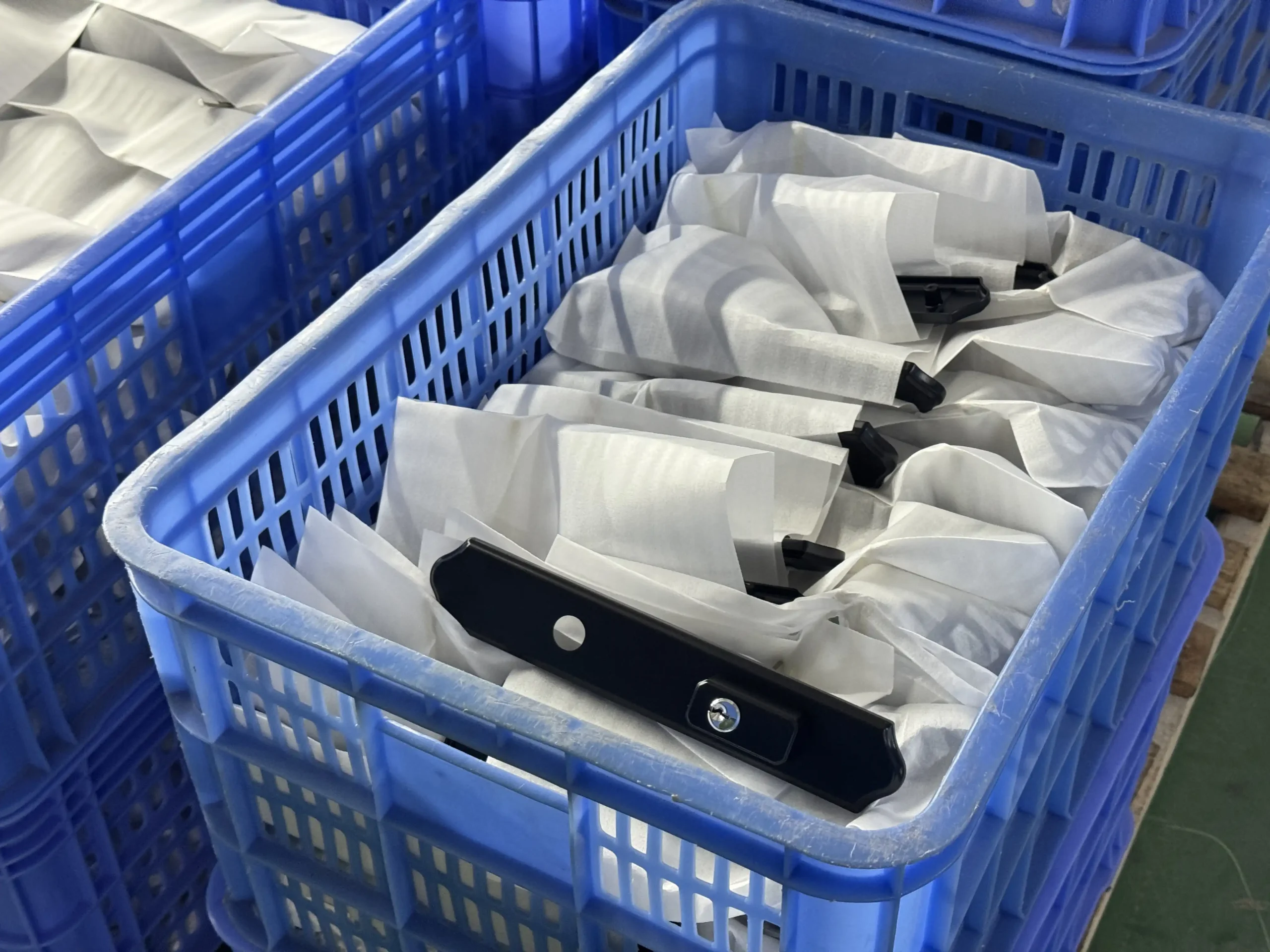 Bulk packaged door handle parts ready for assembly and export at Zhongshan Huachuang factory