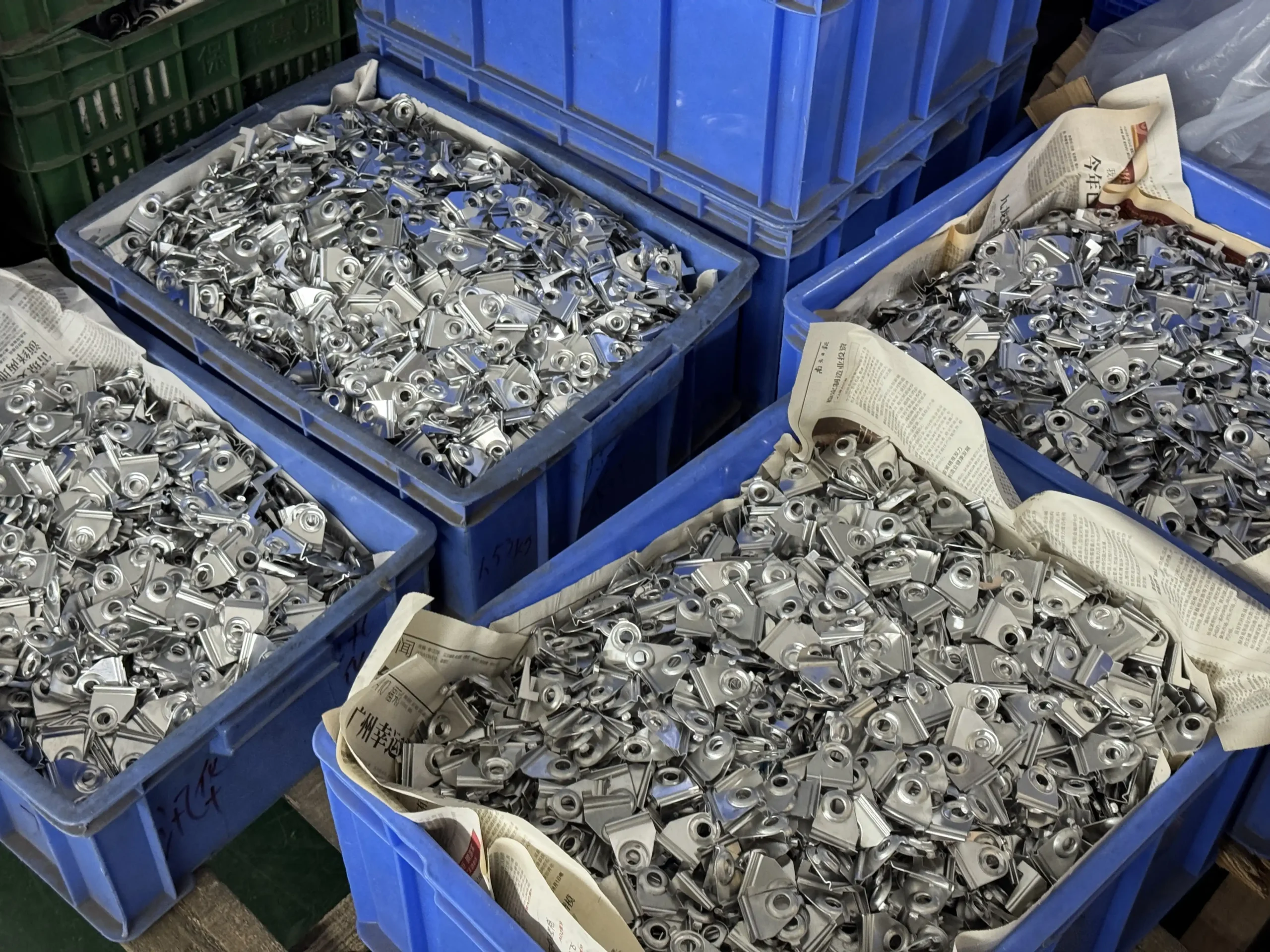 Small metal hardware parts prepared for door and window hardware assembly