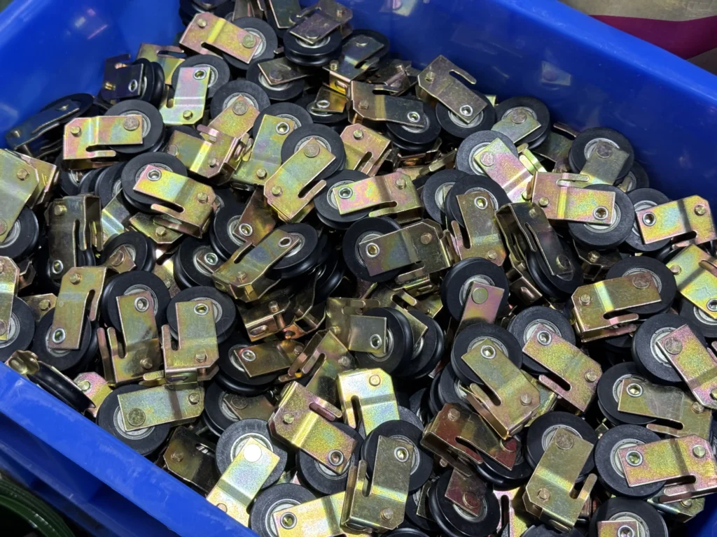 Stamped metal lock components for sliding door hardware production