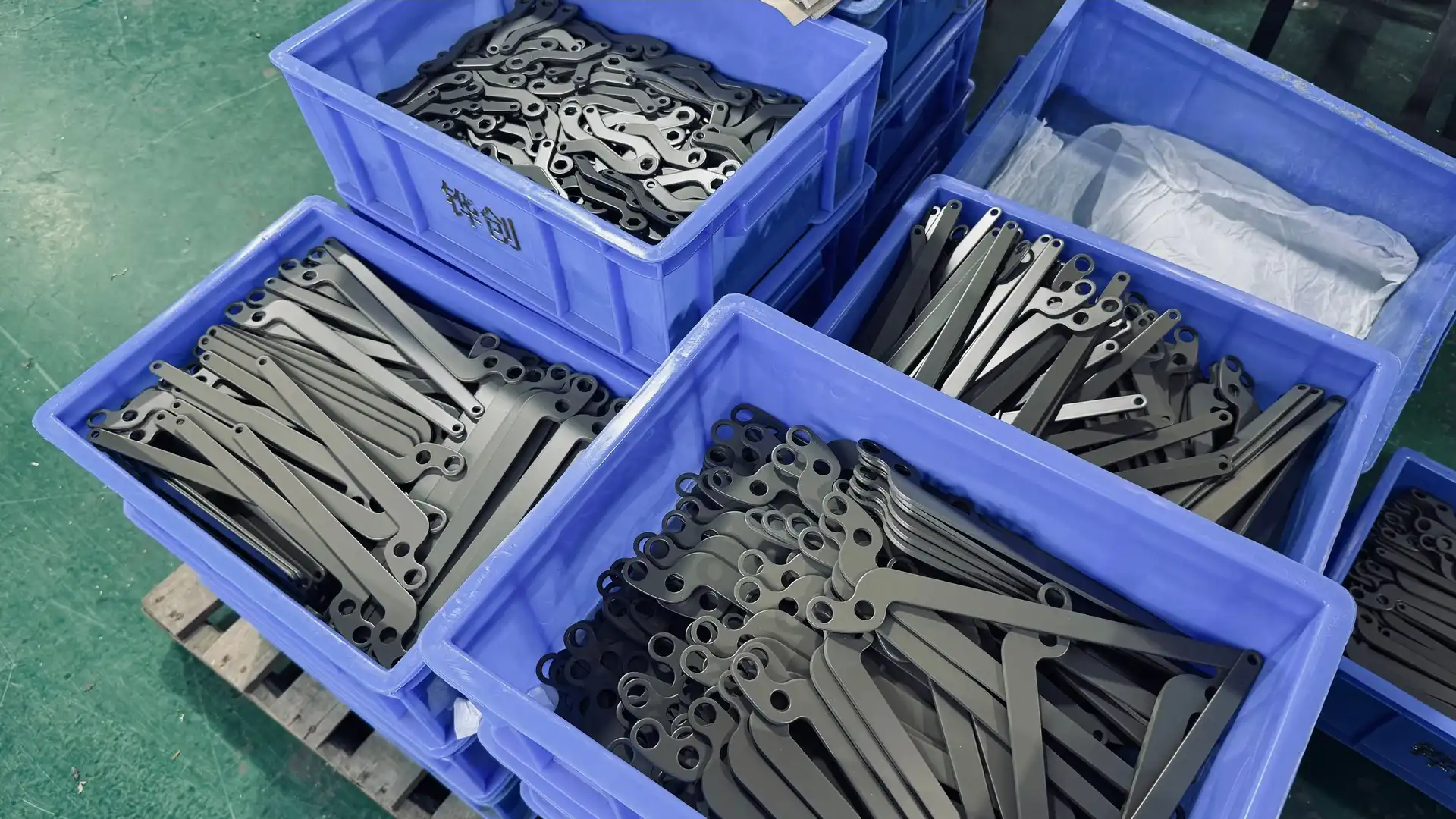 Bulk zinc die cast exterior pull handles stored in factory logistics bins