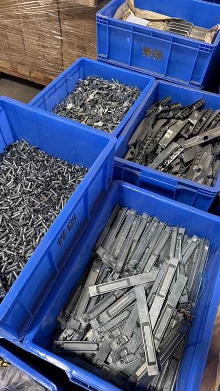 Stamped metal components and friction stay hinges for aluminum sliding windows stored in factory crates