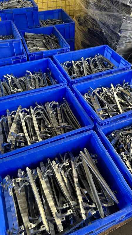 Internal mechanism metal parts for aluminum sliding window sash locks stacked in factory containers